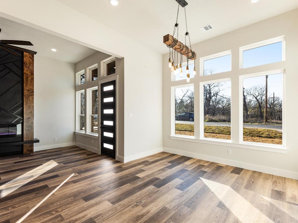 5018 Point La Vista Road Malakoff, TX 75148 - Photo 13 of 32 Unfurnished dining area with wood finished floors, recessed lighting, and a fireplace