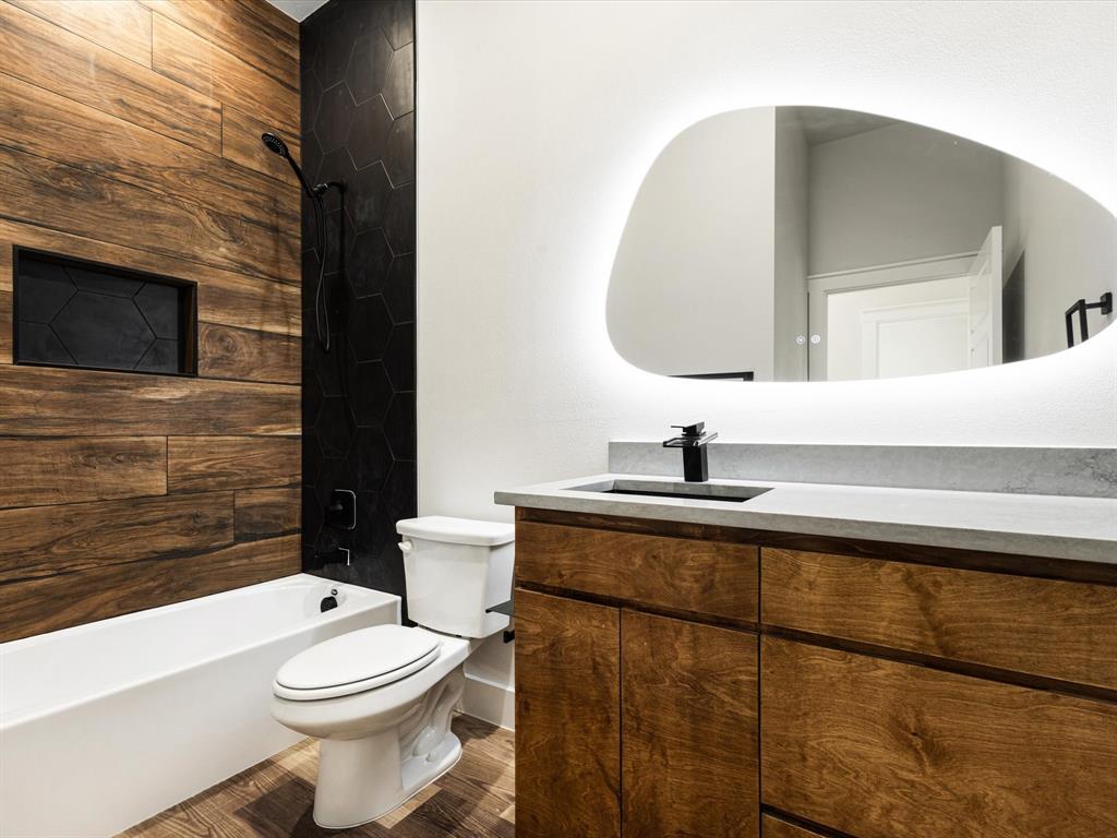 5018 Point La Vista Road Malakoff, TX 75148 - Photo 26 of 32 Bathroom featuring vanity, shower / tub combination, and dark wood finished floors