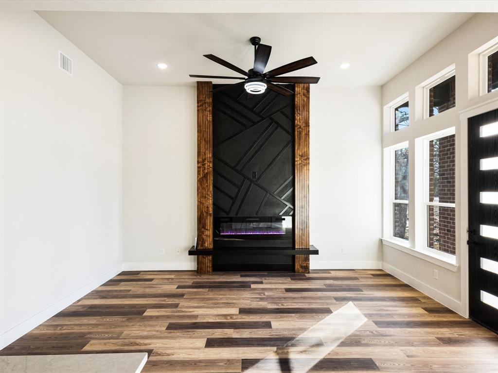 5018 Point La Vista Road Malakoff, TX 75148 - Photo 7 of 32 Unfurnished living room with wood finished floors, ceiling fan, recessed lighting, and a fireplace