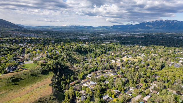 1365 Sumac Drive Logan, UT 84321 - Photo 55 of 66 Expansive aerial perspective showcasing a developed residential area with abundant mature trees and mountainous terrain