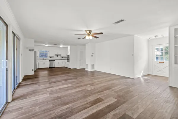 wooden floor in an empty room with a window