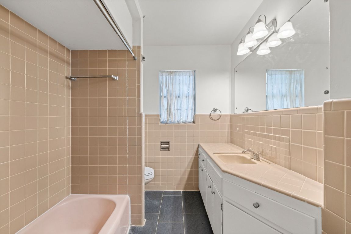 2326 Hartford Road Austin, TX 78703 - Photo 22 of 28 a bathroom with a sink a toilet a mirror and shower