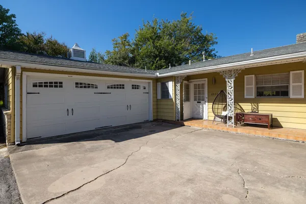 a view of a house with backyard and sitting area
