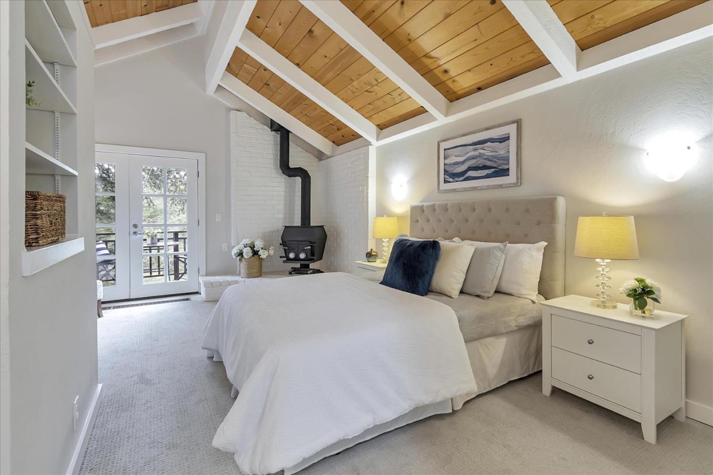 303 Midway Ranch Road Boulder Creek, CA 95006 - Photo 13 of 32 a spacious bedroom with a bed a mirror and lamp