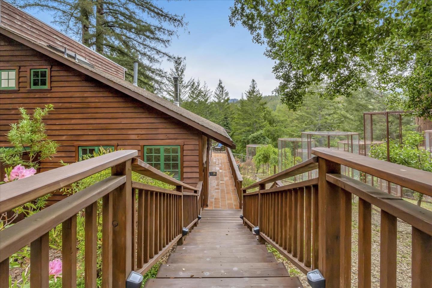 303 Midway Ranch Road Boulder Creek, CA 95006 - Photo 2 of 32 a view of wooden house with a small yard