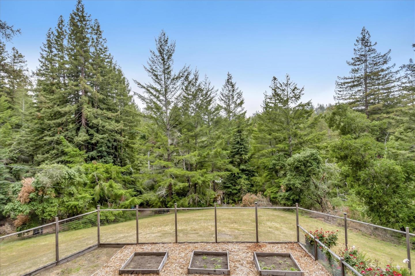 303 Midway Ranch Road Boulder Creek, CA 95006 - Photo 27 of 32 a view of a fence and trees