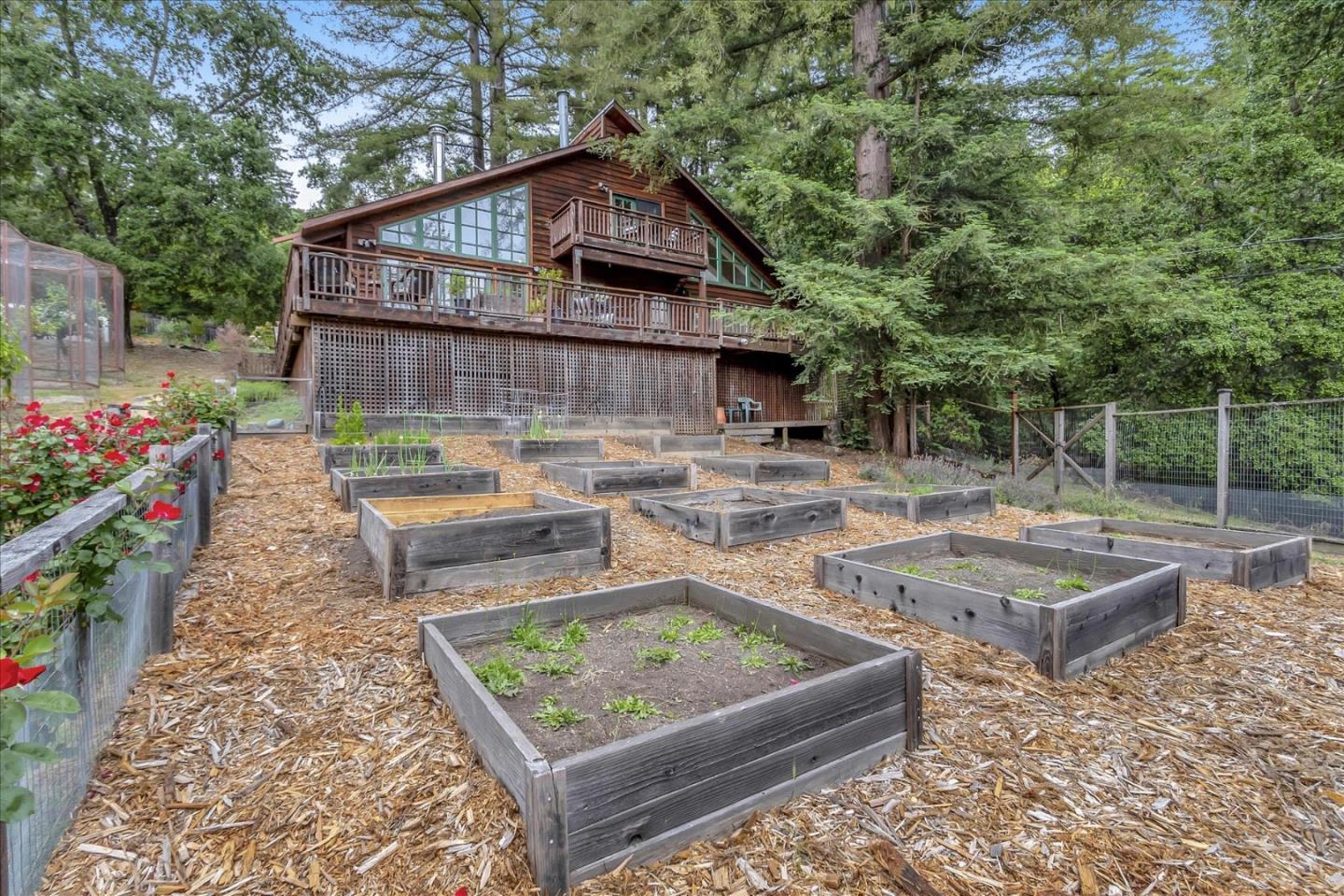 303 Midway Ranch Road Boulder Creek, CA 95006 - Photo 29 of 32 a front view of house with garden space and seating