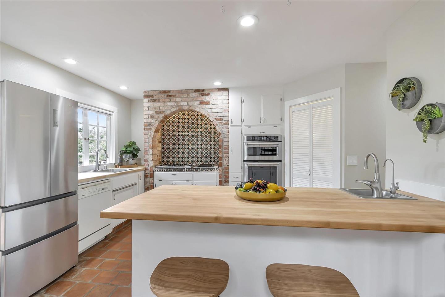 303 Midway Ranch Road Boulder Creek, CA 95006 - Photo 7 of 32 a kitchen with a sink a stove and chairs