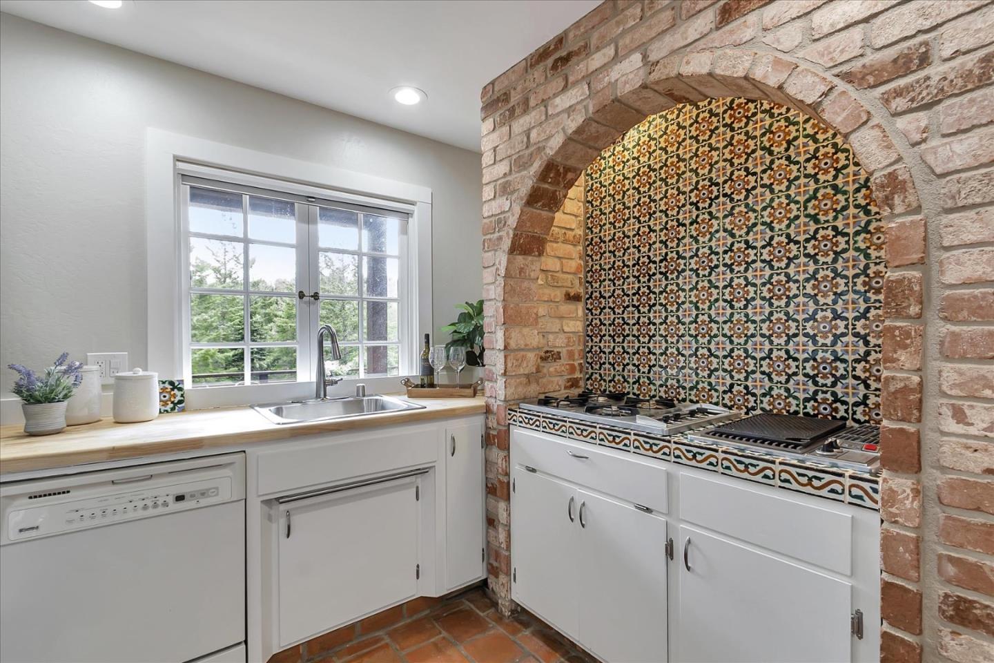 303 Midway Ranch Road Boulder Creek, CA 95006 - Photo 8 of 32 a kitchen with a sink a window and cabinets