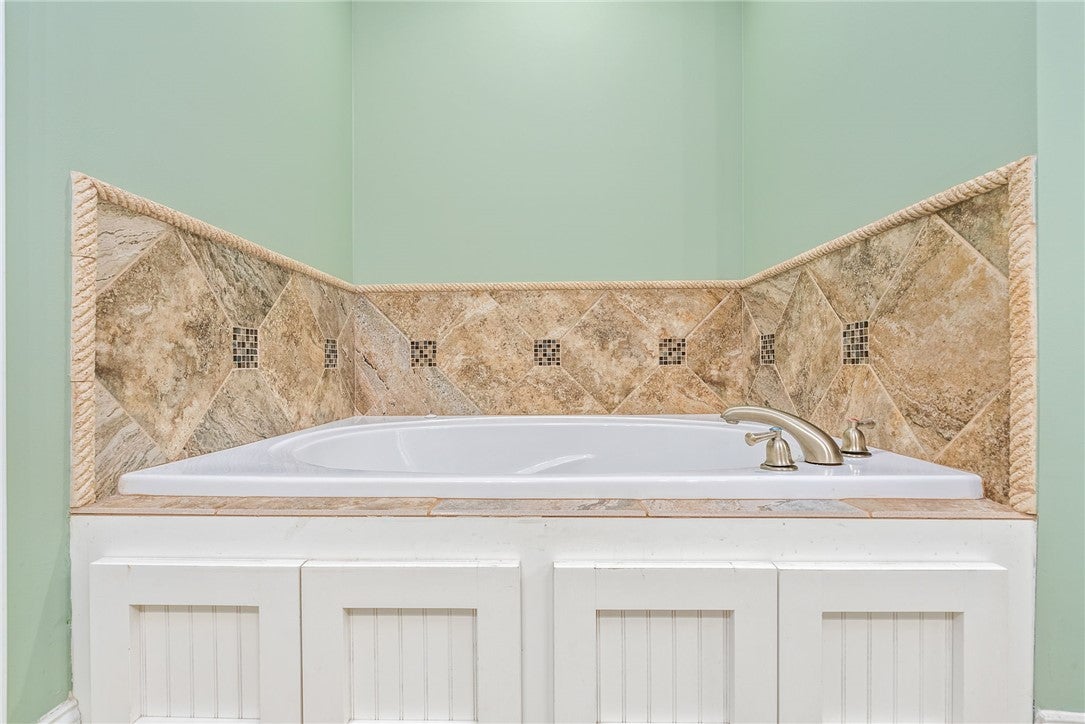 1284 Lee Road Salem, AL 36874 - Photo 15 of 24 Relax and unwind in this inviting bathroom featuring a tiled soaking tub.