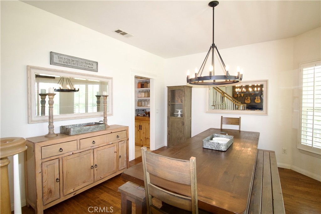 35159 El Dorado Road Lake Elsinore, CA 92530 - Photo 16 of 72 a view of a dining room with furniture and wooden floor