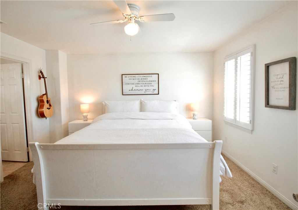 35159 El Dorado Road Lake Elsinore, CA 92530 - Photo 35 of 72 a bedroom with a large bed and a chandelier