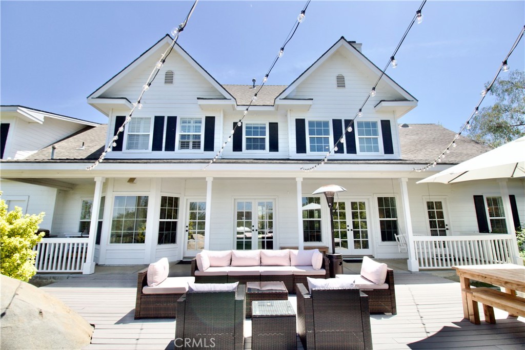35159 El Dorado Road Lake Elsinore, CA 92530 - Photo 41 of 72 a view of a patio with couches table and chairs and potted plants