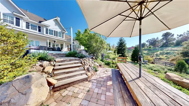 a view of yard with seating area and trees around