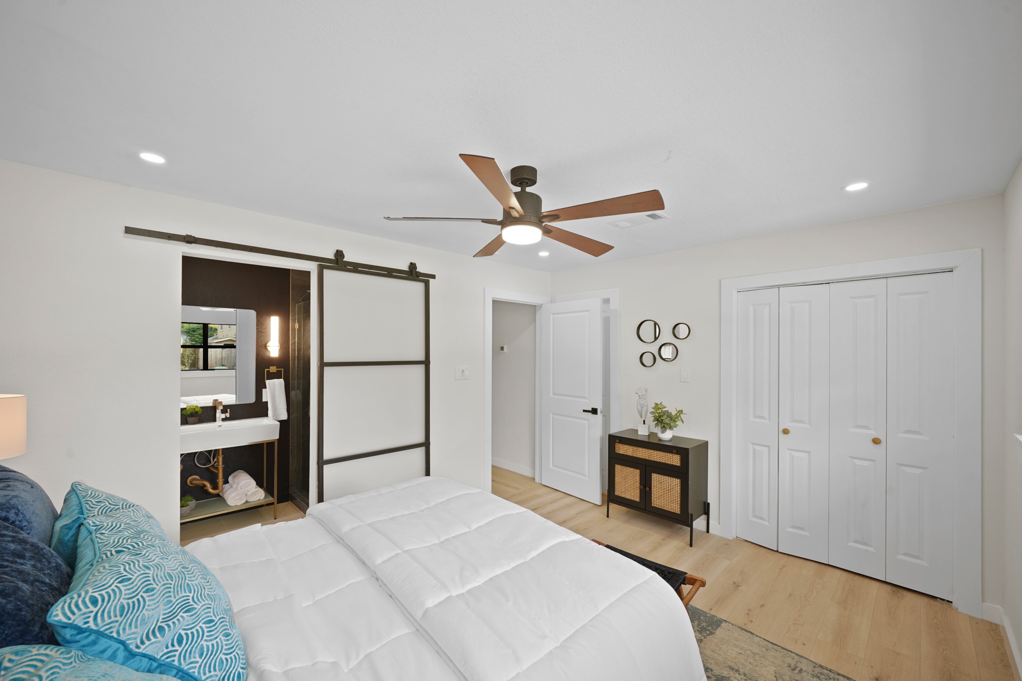 4813 Hummingbird Street Houston, TX 77035 - Photo 14 of 50 An Onyx Hued Contemporary Style Exterior Hinged Barn Door with Frosted Glass Panels adds a Stylish Look to the Primary Suite. The Primary Suite features 2 Closets---an Extra Large Walk in Closet plus an Additional Wardrobe Closet with Built in Shelf and Hanging Rod.