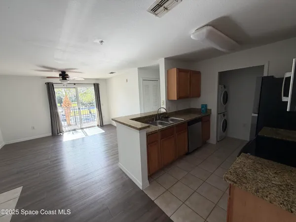 a kitchen with granite countertop a stove and a refrigerator