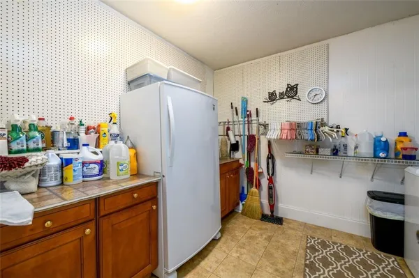 a view of a kitchen with fridge and workspace