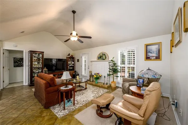 a living room with furniture a couch and a window