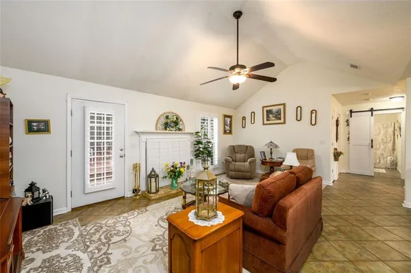 a living room with furniture a fireplace and a flat screen tv