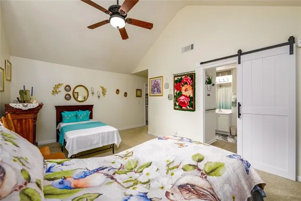 a bedroom with two beds and a couch