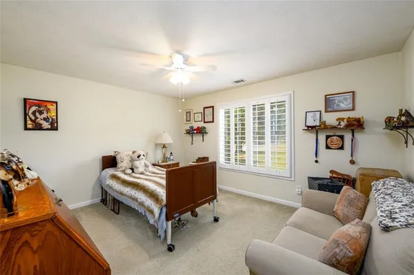 a spacious bedroom with a bed and a couch