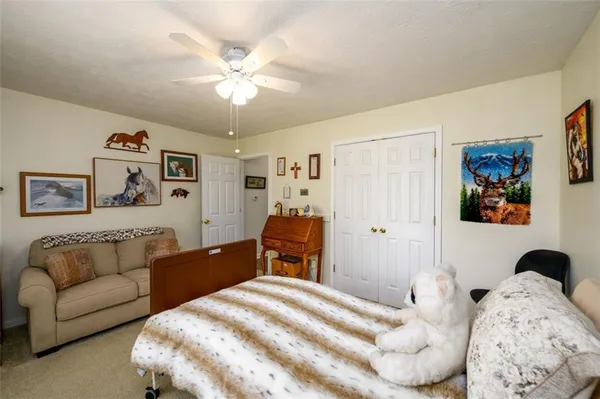 a bedroom with a large bed and a chandelier