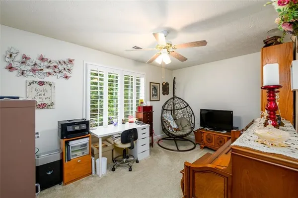 a view of a livingroom with workspace and a window