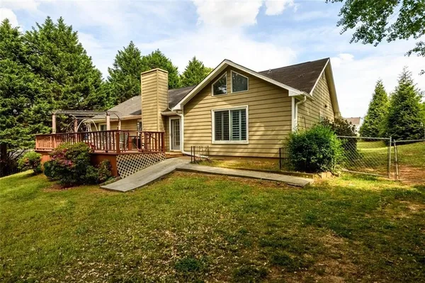 a view of a house with yard and sitting area
