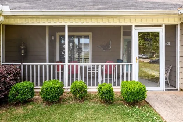 a view of a house with a small yard and plants