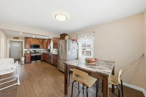 a kitchen with granite countertop lots of counter top space and stainless steel appliances