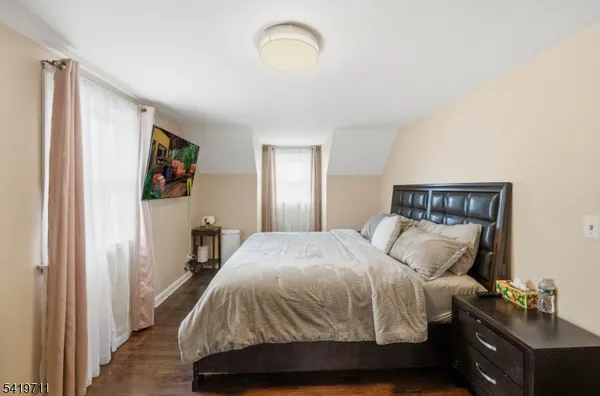 a bedroom with a bed and a painting on the wall