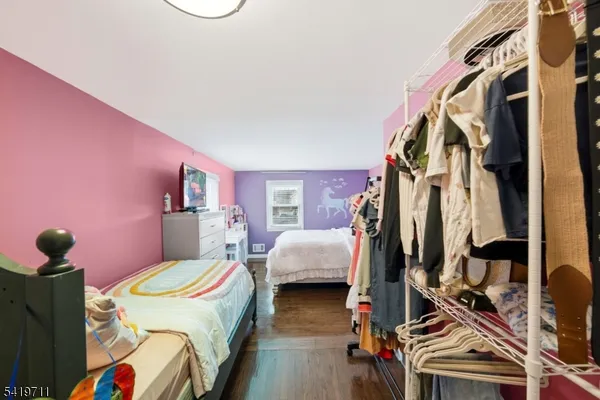 a bedroom with bed and a couch