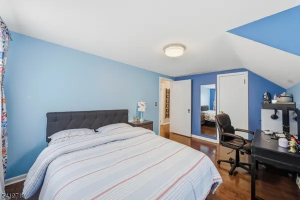 a bedroom with a bed a table and chair