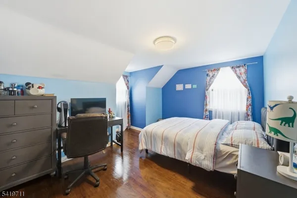 a bedroom with a bed chair and dresser