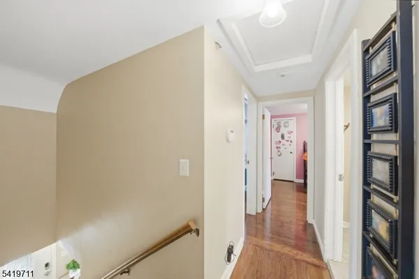 a view of a hallway with a wooden floor