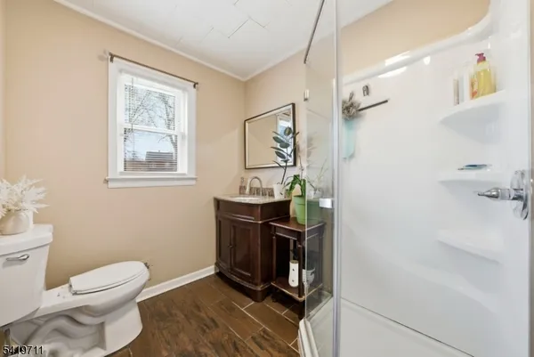 a bathroom with a toilet a sink and mirror