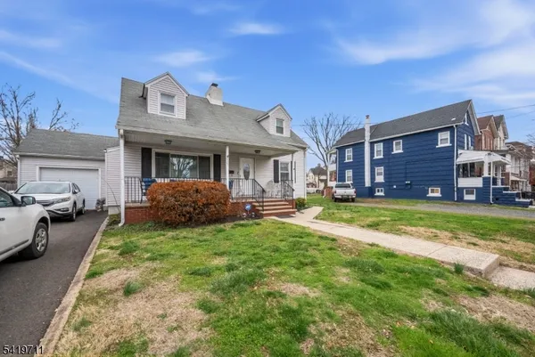 a view of a house with a big yard and large trees