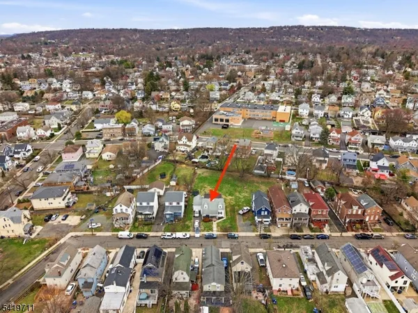 an aerial view of residential houses with city view