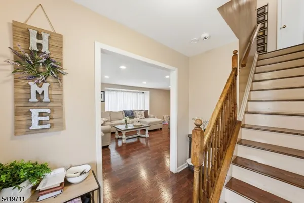 a dining room with wooden floor and entrance