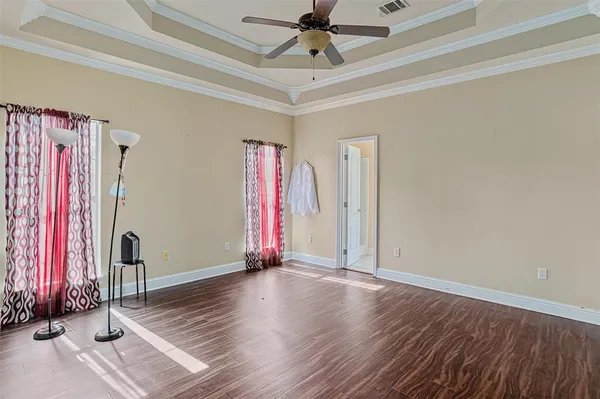 a view of a room with wooden floor and window