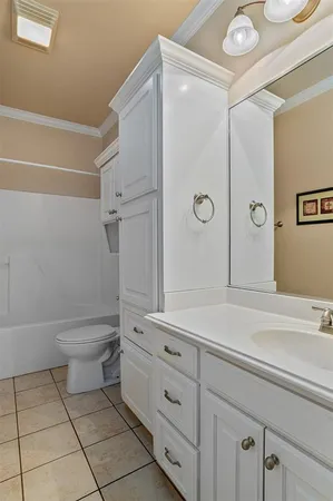 a bathroom with a toilet a sink a mirror and shower
