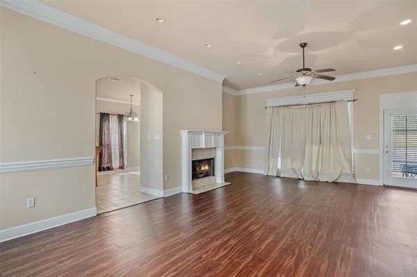 a view of a livingroom with wooden floor fireplace and window