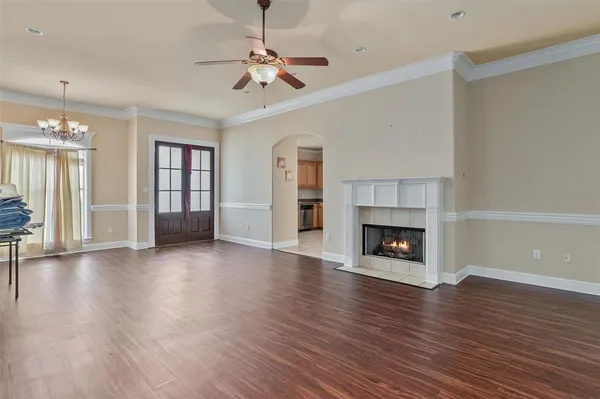 wooden floor fireplace and windows in an empty room