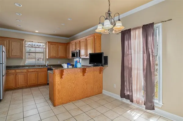 a kitchen with stainless steel appliances granite countertop a refrigerator a sink a stove a microwave and island