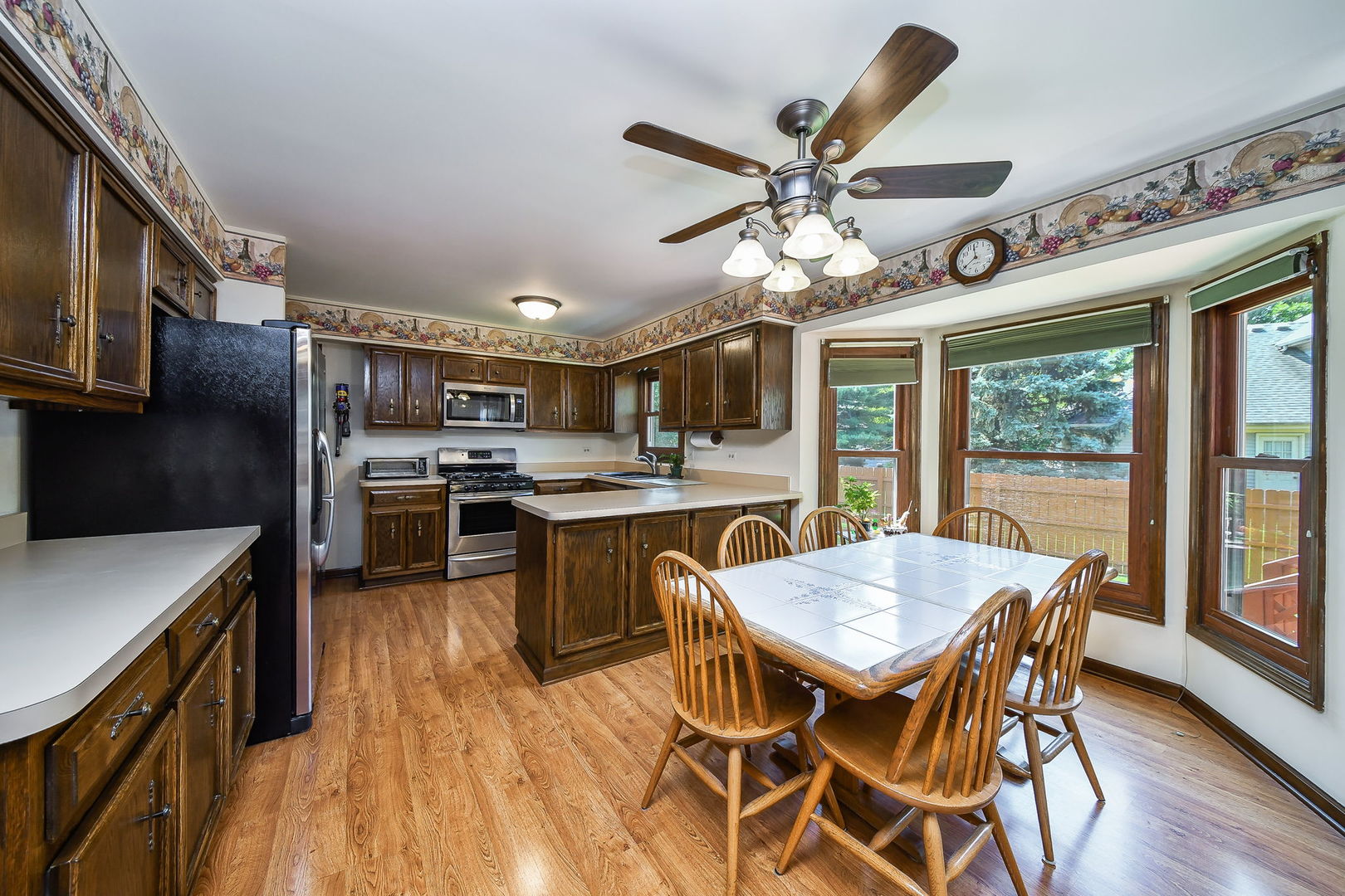 516 Cassin Road Naperville, IL 60565 - Photo 6 of 23 a view of a dining room with furniture window and wooden floor