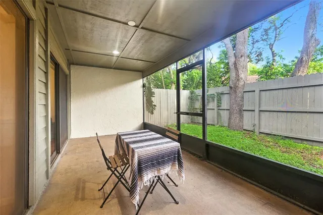 a view of yard from deck with patio