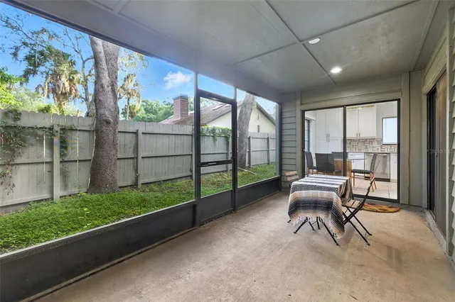 a view of a porch with furniture and garden