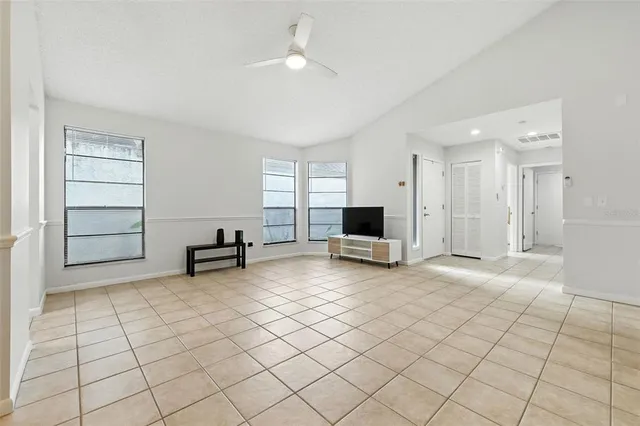 a view of a livingroom with workspace and a window