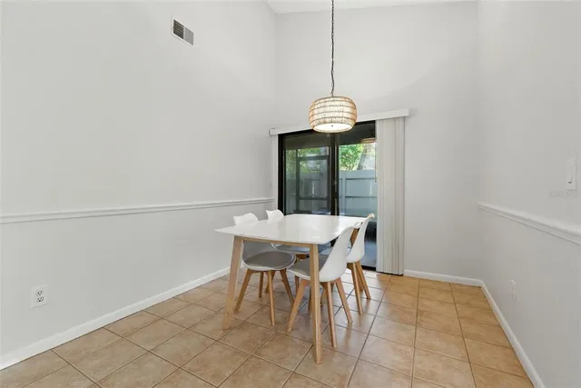 a view of a dining room with furniture wooden floor and chandelier