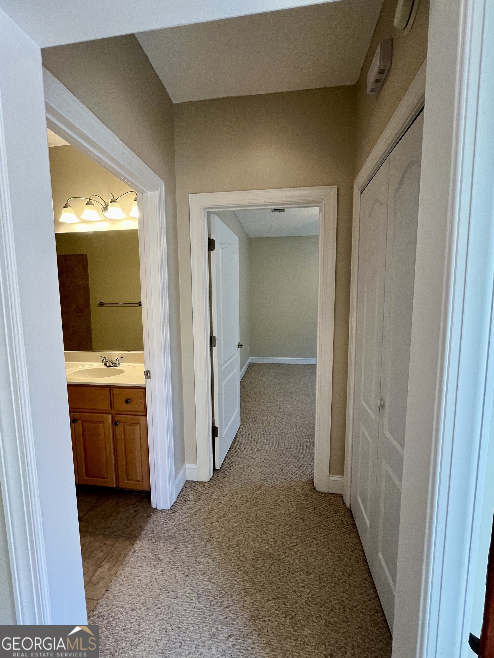 49 Coastal Walk St. Marys, GA 31558 - Photo 18 of 42 a view of hallway with sink and wooden floor